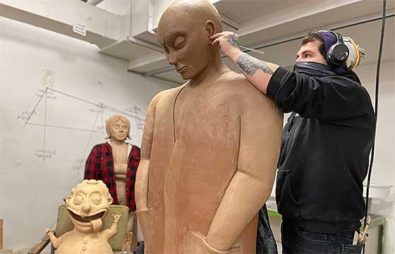 tyler on the right working on a larger than life clay sculpture